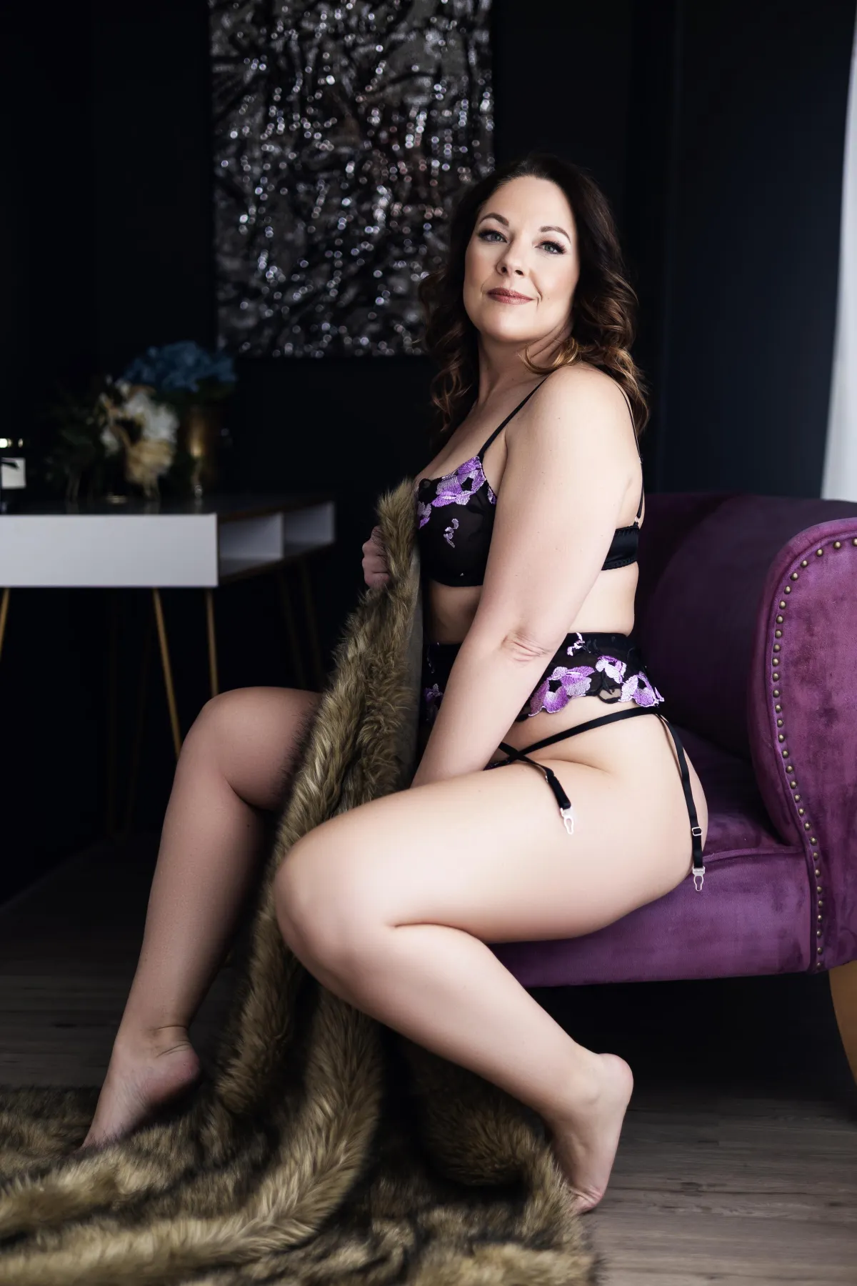 Minneapolis Boudoir woman posing with blanket on chair in lingerie