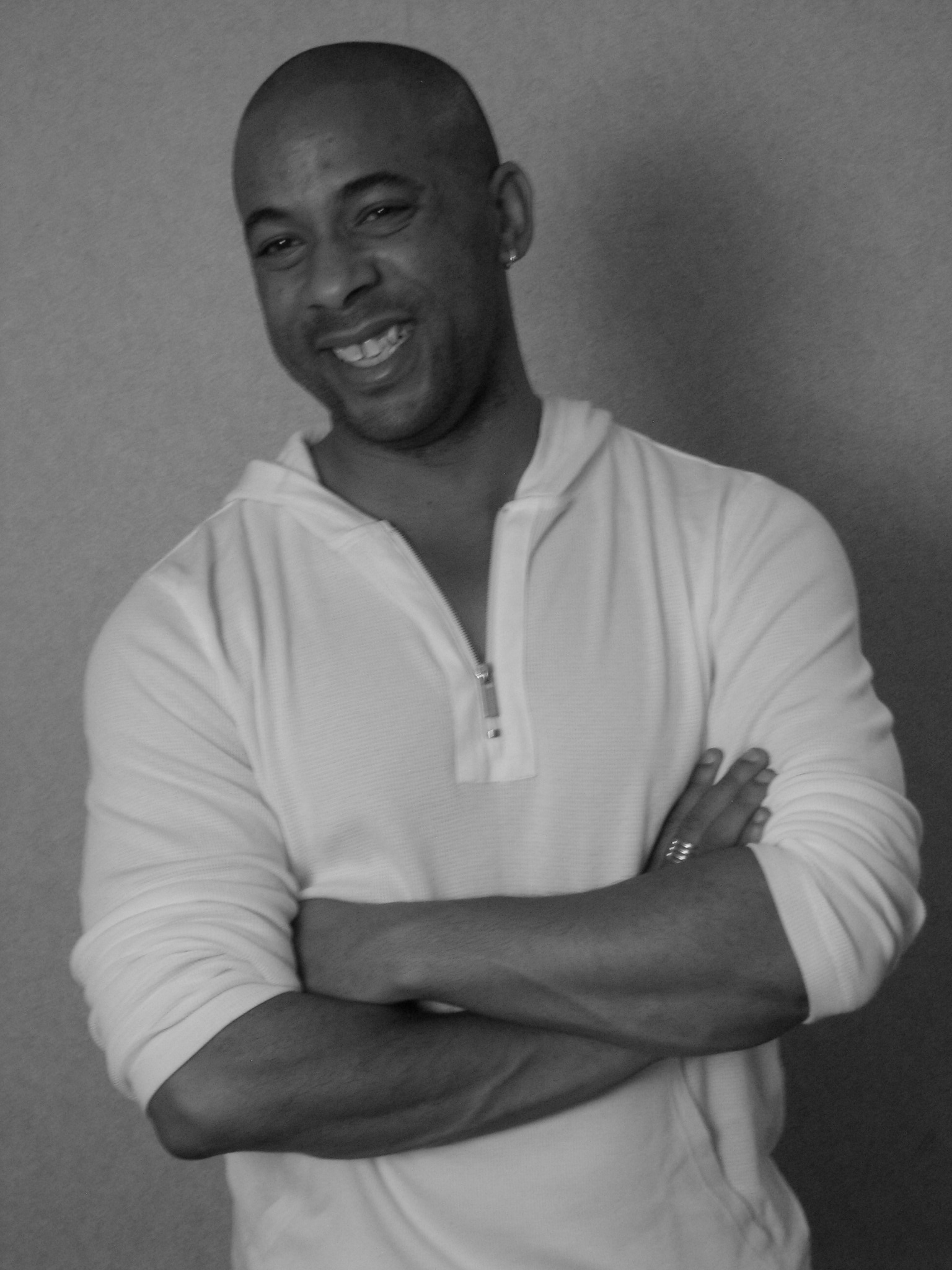 Half-body portrait of Clint Pracher, early 40s, smiling confidently in a bright minimalist home office.