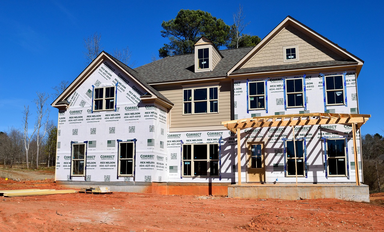 home under construction with a vacant lot