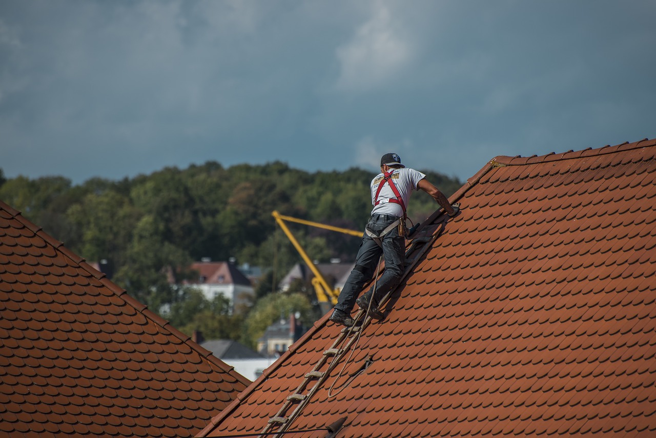 guy on lay roof installing for roofing contractor