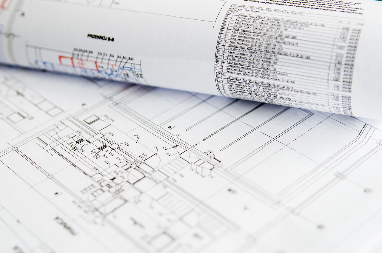 a roll of construction drawings on a plan table
