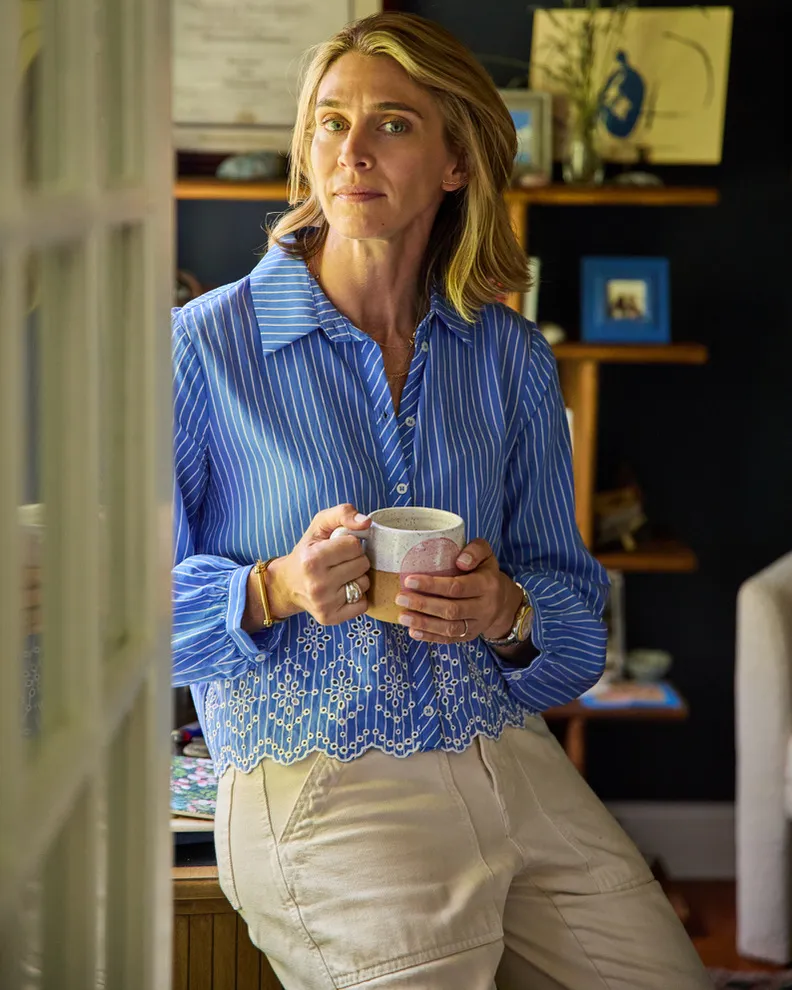 Maris Pasquale Doran holding a mug, looking at the camera.