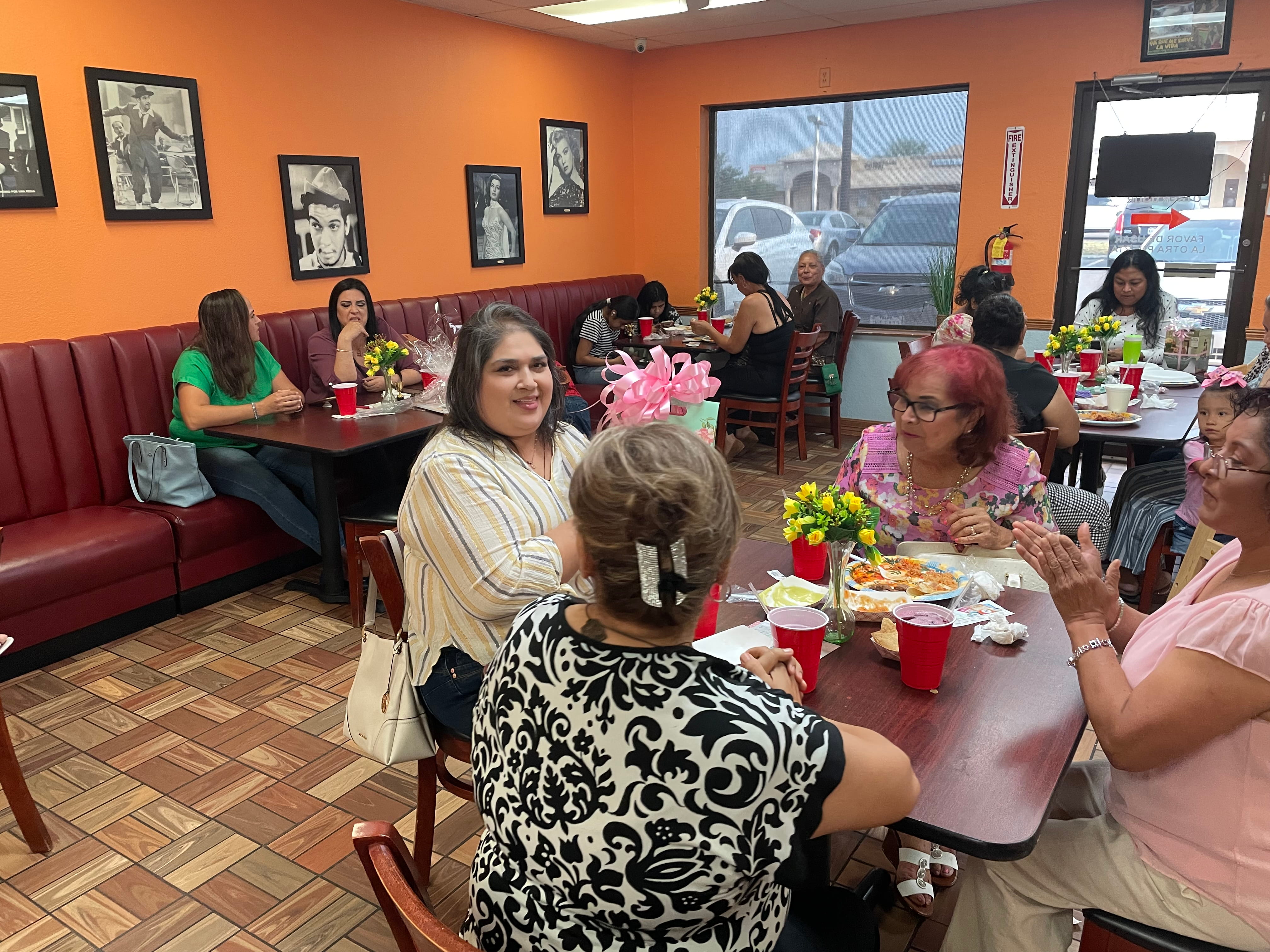 Friends are enjoying a party, pouring wine.