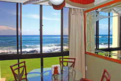 A spacious master bedroom with a king bed, crisp white linens, and sliding doors opening to a lush garden. Soft natural light fills the room, creating a peaceful, restful atmosphere.