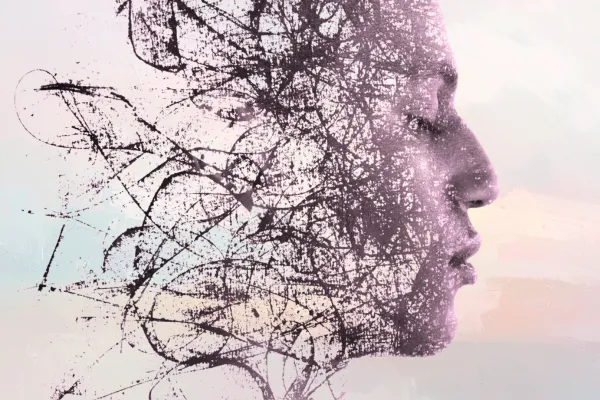 Side profile of a person with abstract, fragmented lines dissolving outward, symbolizing mental overwhelm and stress-driven overthinking.