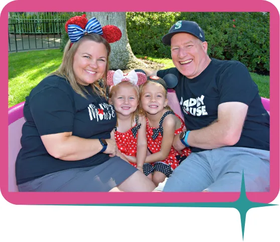 two parents and two kids wearing mouse ears in the tea cup at disneyland