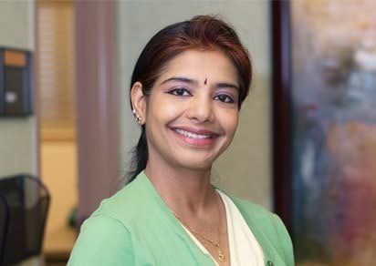 A serene sound healing session with Tibetan singing bowls arranged on a soft mat, sunlight streaming through a window, and a practitioner gently playing a bowl. The setting is tranquil, inviting, and filled with natural light, evoking calm and balance.