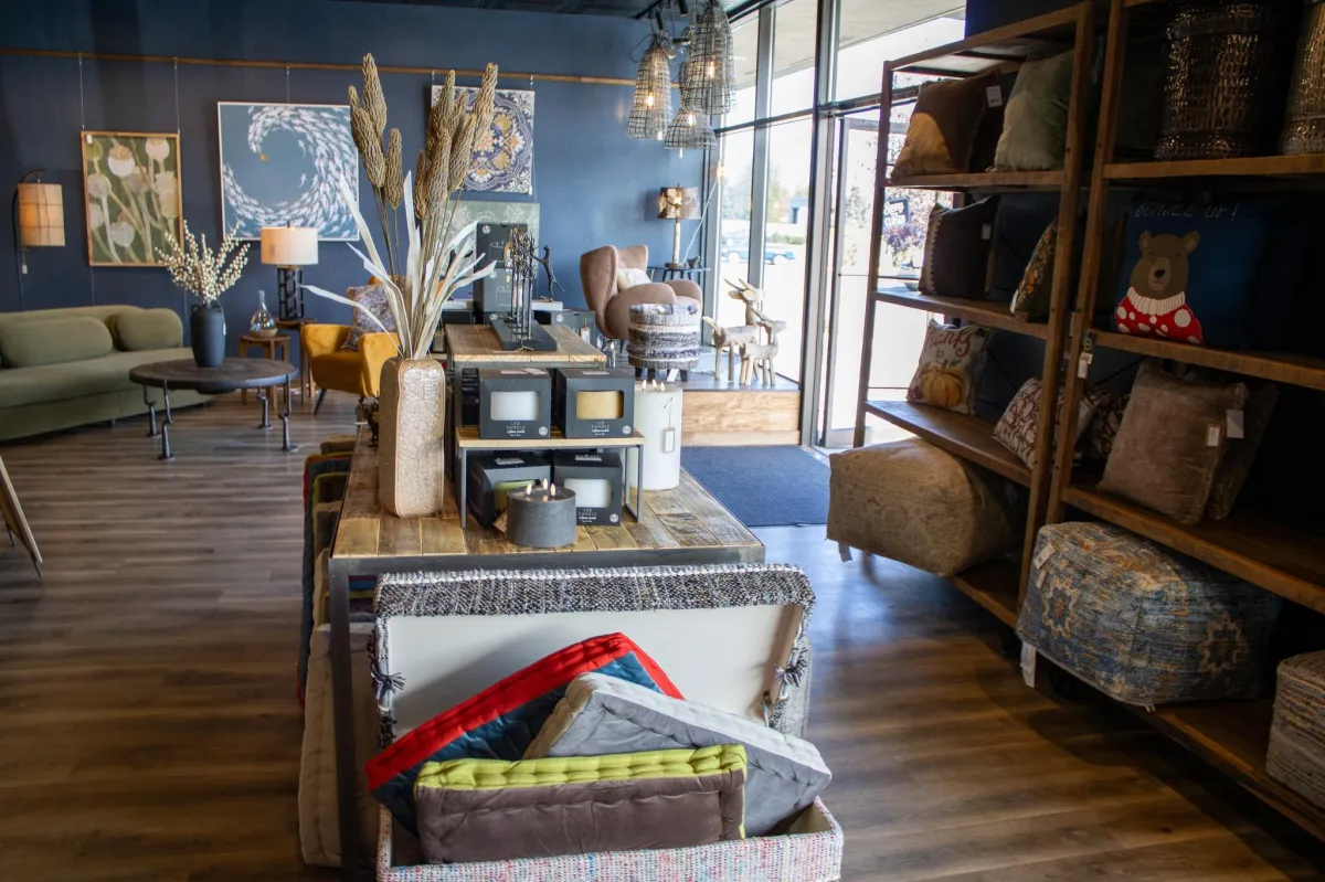 Detailed product shot: plush sofa and oak side table staged with layered textiles and warm light, shallow depth of field, editorial photographic style to highlight texture and craftsmanship.