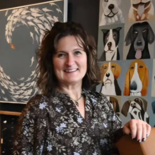 Smiling furniture consultant discussing design plans with a homeowner in a bright, stylish office