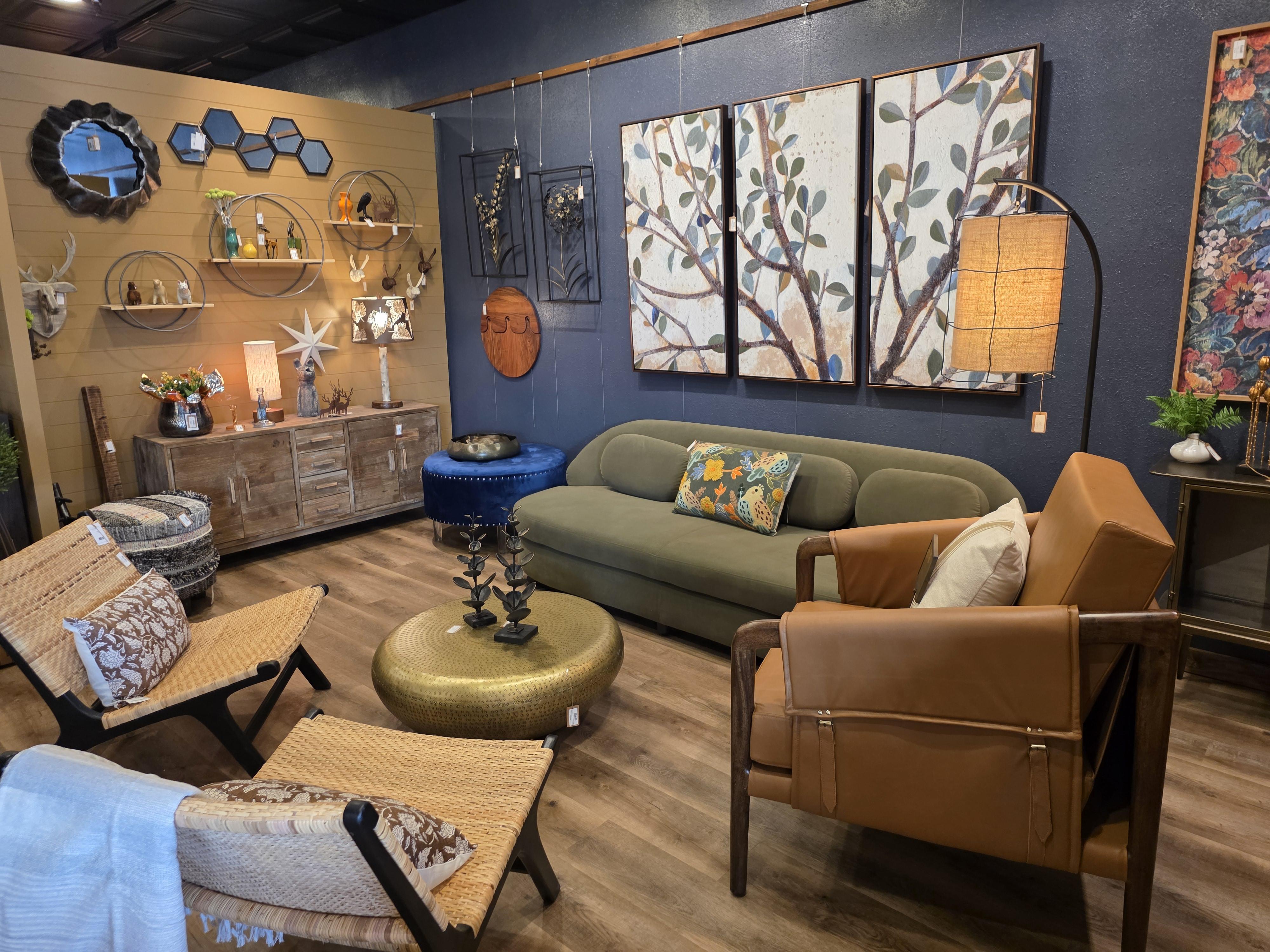 Modern living room with elegant furniture, soft blue and gold accents, large windows, and a welcoming atmosphere