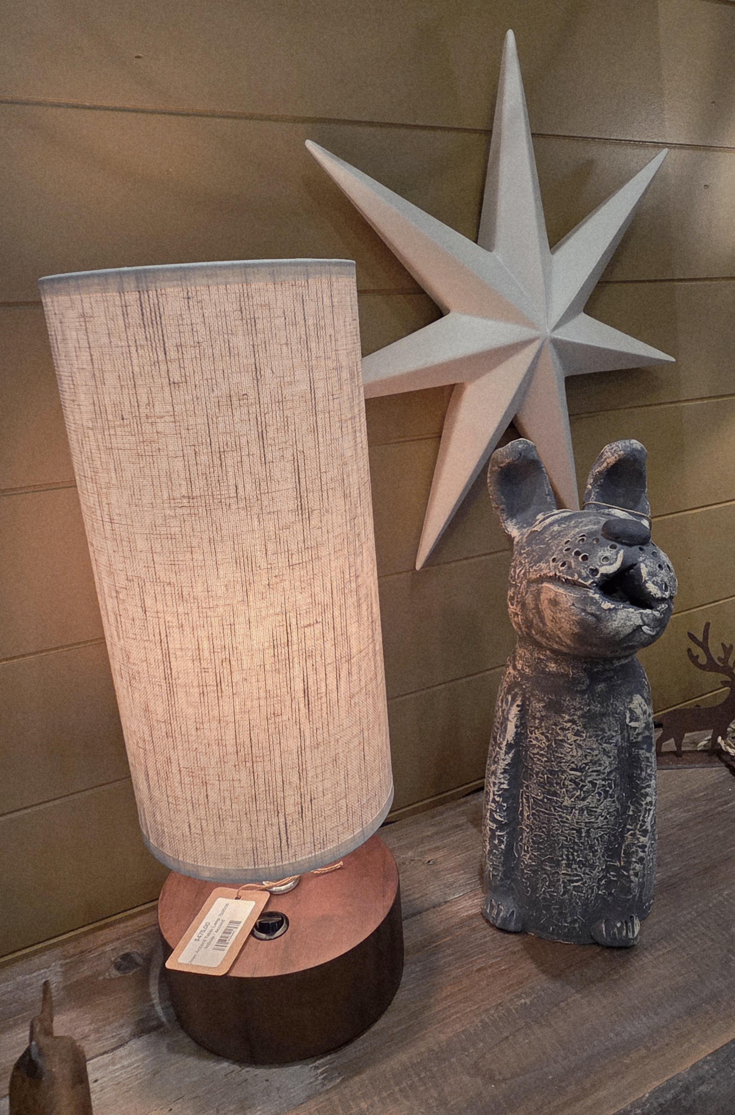 Detailed product shot: plush sofa and oak side table staged with layered textiles and warm light, shallow depth of field, editorial photographic style to highlight texture and craftsmanship.
