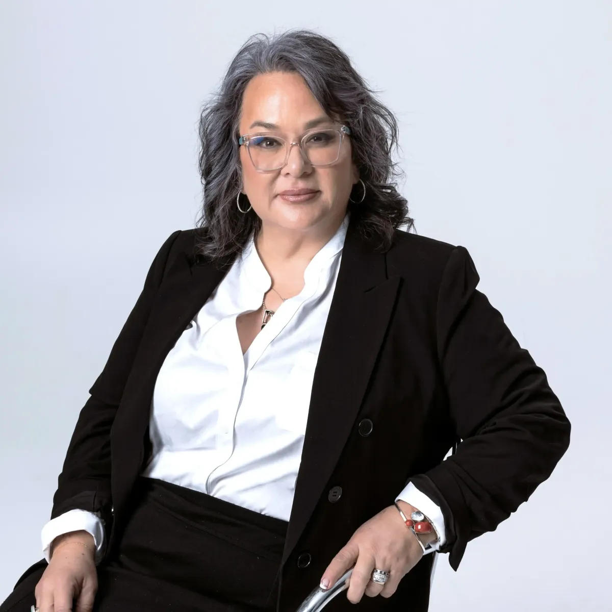 Barbara Franklin, founder of Chrome Aesthetics, sitting in the clinic’s modern treatment space.