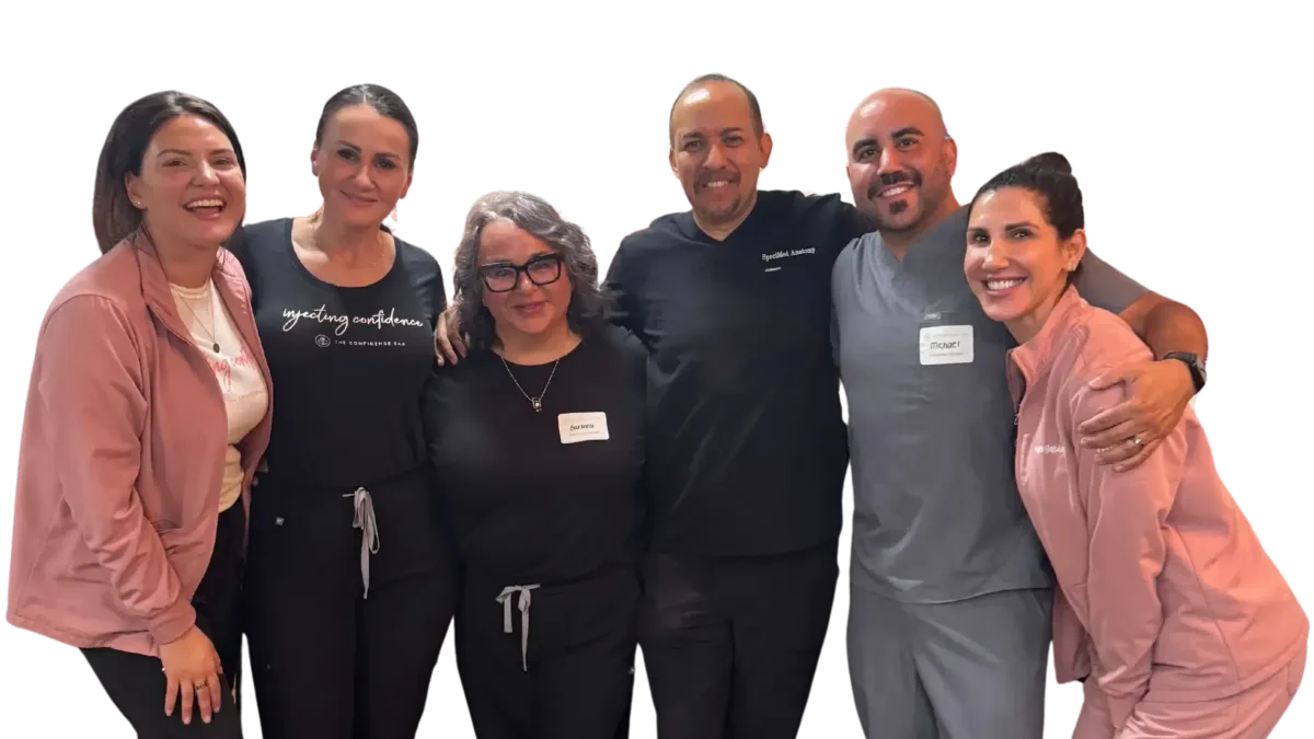 Group of medical injector trainees posing together after completing the cadaver dissection training session.