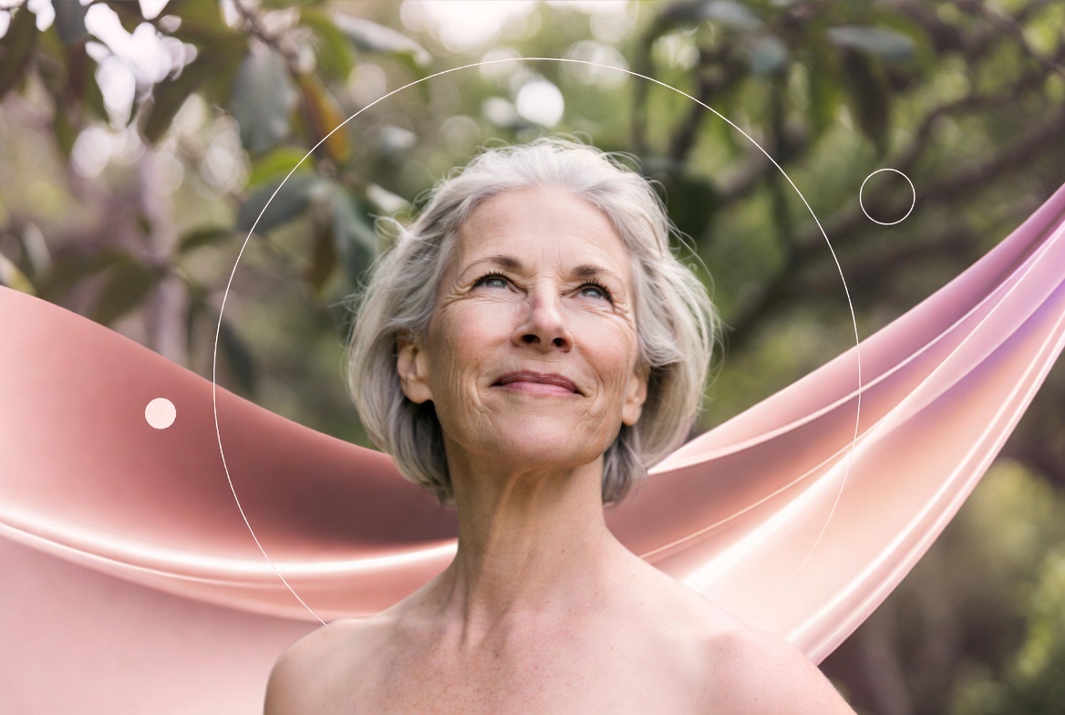 A confident, smiling older woman with short gray hair and visible wrinkles looks upward, her shoulders bare against a blurred green foliage background. Flowing pink and purple abstract satin-like ribbons wrap around her, with white circular line graphics overlaid, symbolizing wellness and empowerment in menopause care.