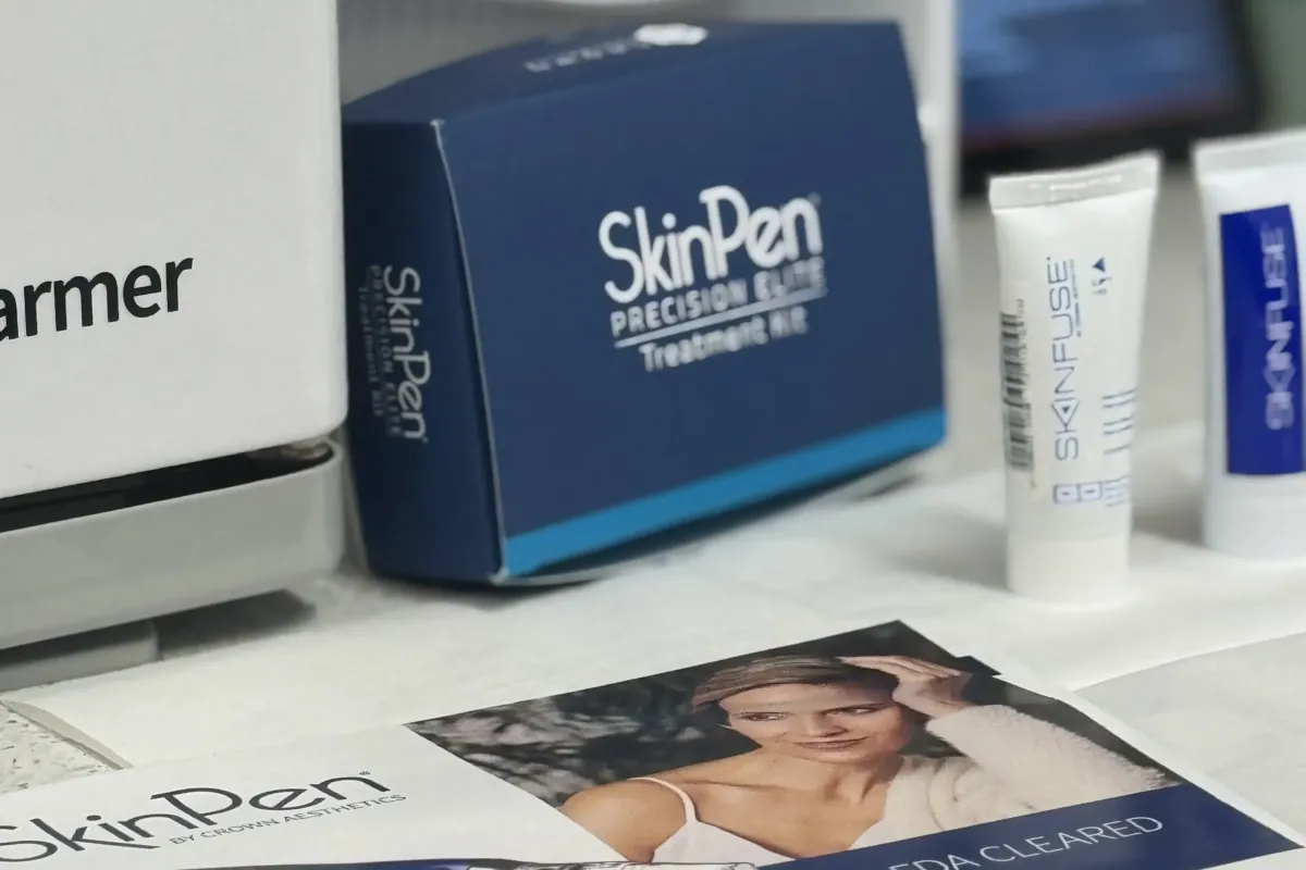 SkinPen Precision Elite microneedling treatment kit displayed with post-care products and promotional materials on a clinical countertop.