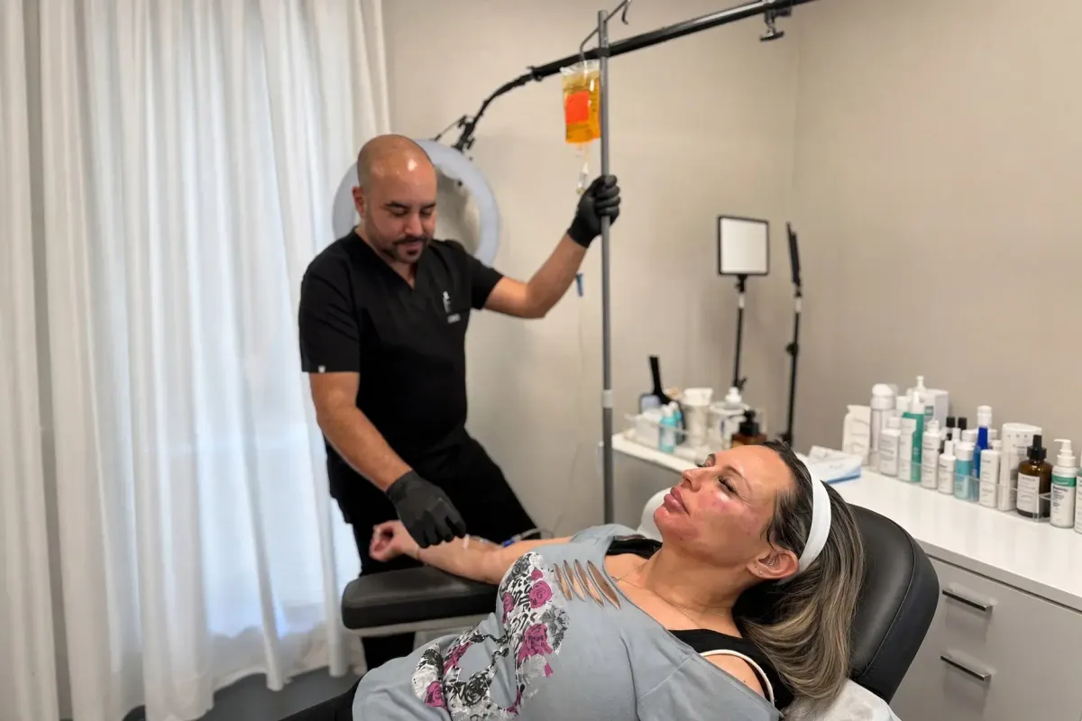 Chrome Academy instructor administering IV therapy during hands-on training session.