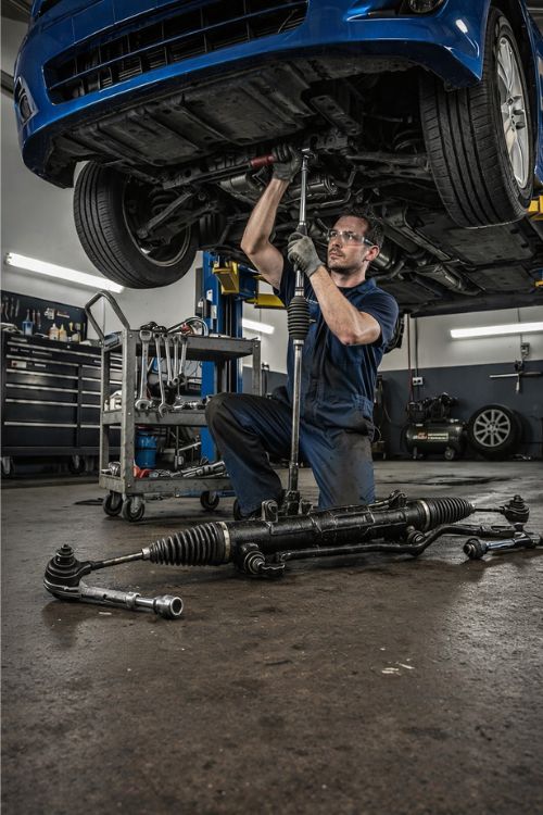 Mechanic working on an alternator at Deals Tires shop