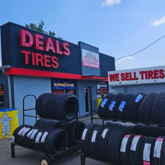 Deas Tires shop exterior photo with new tires placed on he front of the tire shop main door