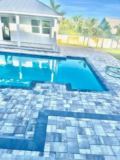 a woman in a long white dress standing next to a car