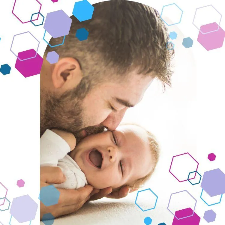 A smiling baby with eyes closed is being kissed on the cheek by their dad. CubCare hexagons are shown around the outside of the image for brand purposes. Image is to represent the Baby Development Course.