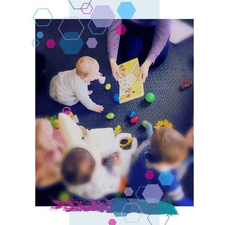 Three babies sitting on the floor surrounded with toys whilst Jilly reads them a story at a CubCare Wriggers Baby Yoga and Sensory class Welwyn Hatfield