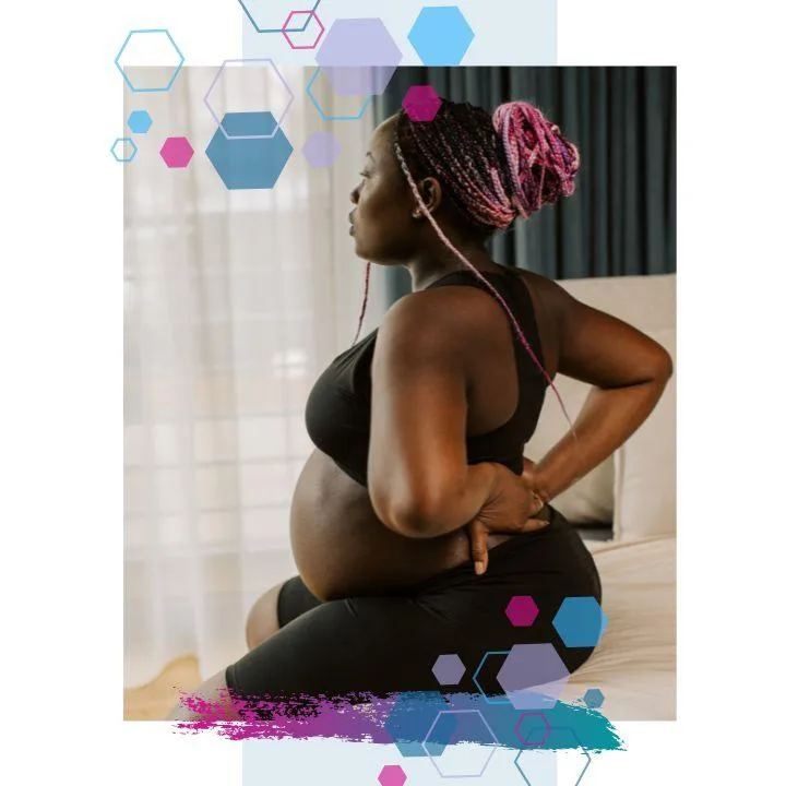 Pregnant person in activewear supporting their lower back while seated, demonstrating hypermobile shoulders and elbows, and a common posture for managing pelvic or lumbar pain in hypermobile pregnancy.