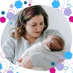 Parent holding a newborn baby while seated, reflecting the postnatal impact of birth preparation with hypermobility support from the CubCare HSD/hEDS antenatal course.