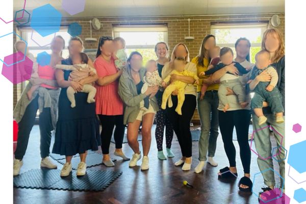 Group of new parents standing together with their babies, smiling after class — a group who originally met through CubCare pregnancy yoga and stayed connected into early parenthood.