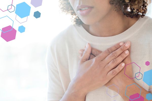 Person placing a hand on their chest, representing breathlessness in early pregnancy around 5–9 weeks.