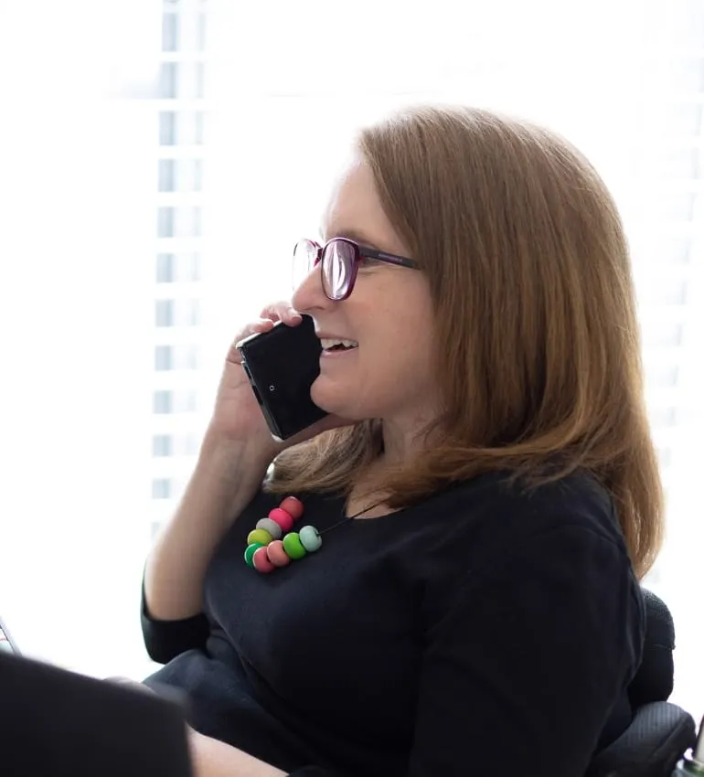 Ainslee Hooper smiling while talking on the phone.