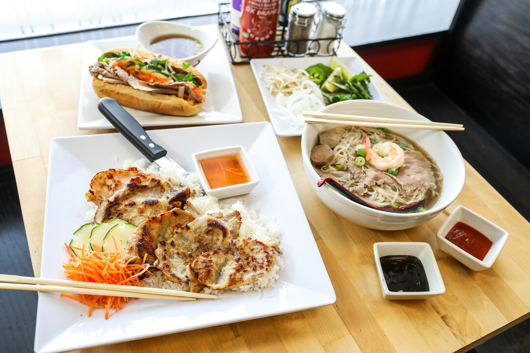 A white plate topped with lettuce wrapped in meat