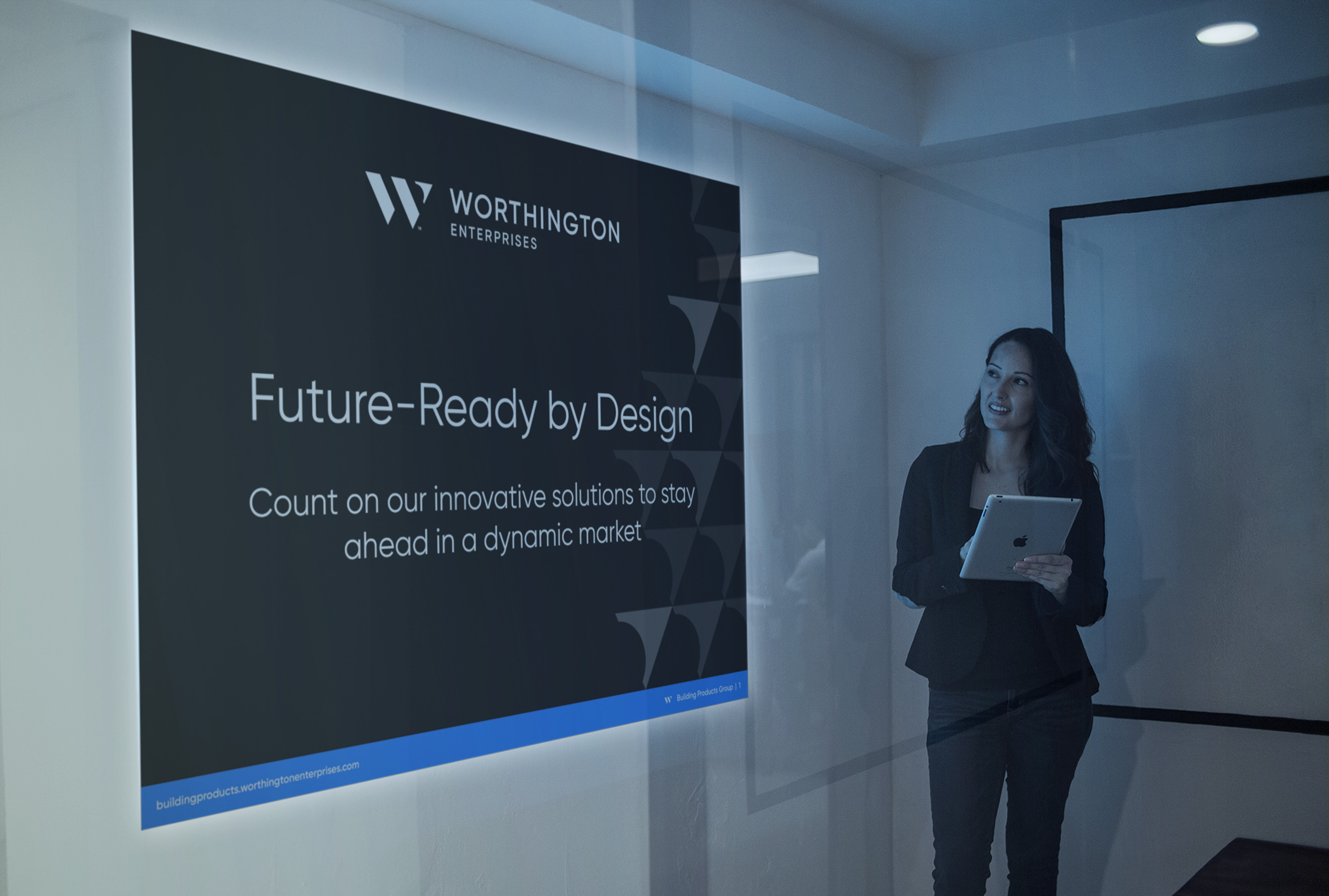 Worthington Enterprises presentation deck on screen in a meeting room