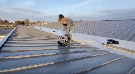Licensed professional fixing a metal roof