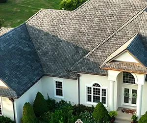 image of a white house with durable grey roof