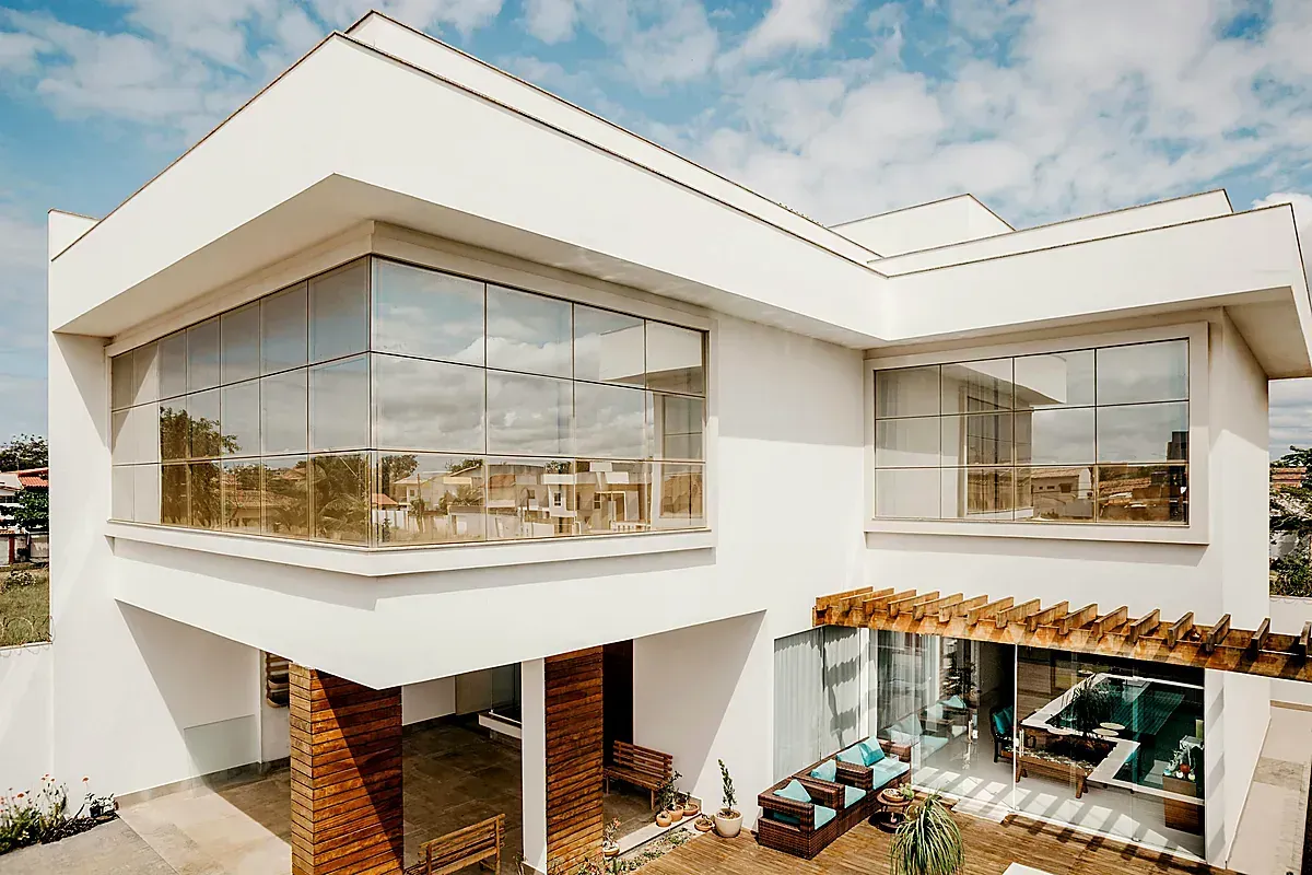 Modern home exterior with large impact-resistant windows for hurricane protection