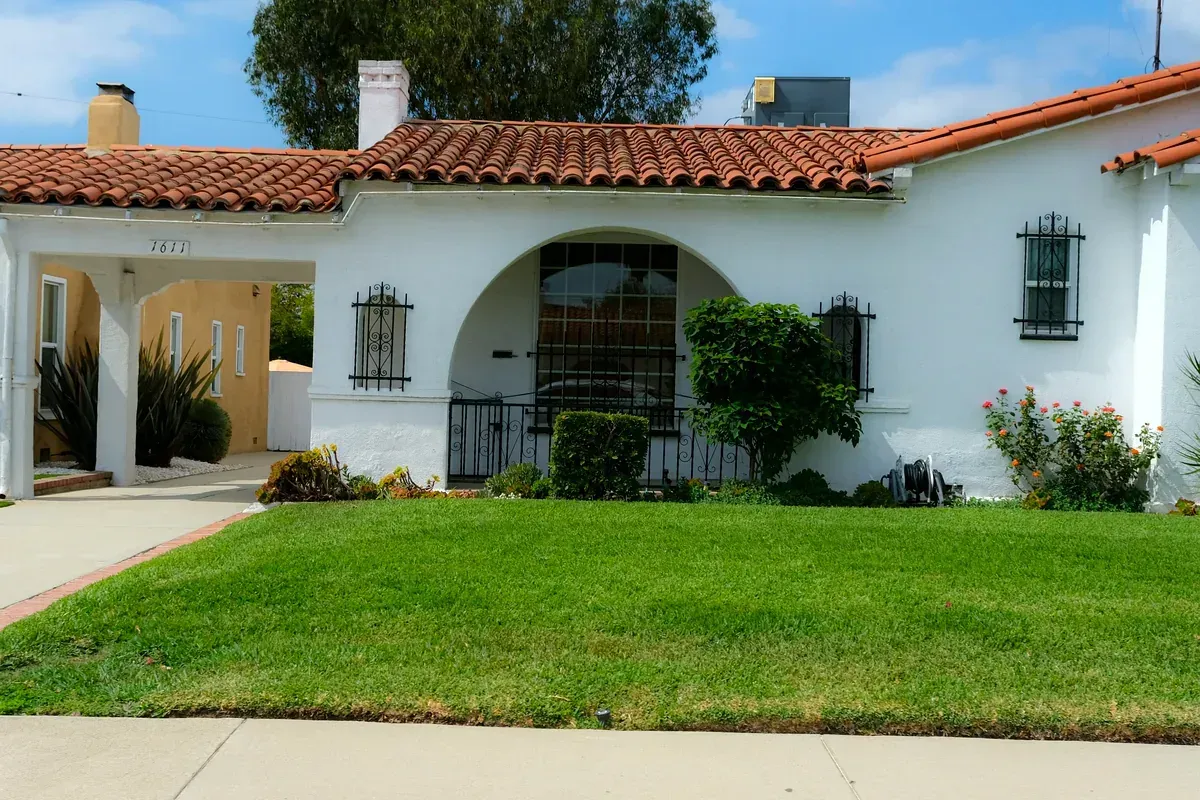 Stucco home with a concrete tile roof showcasing Florida-style curb appeal