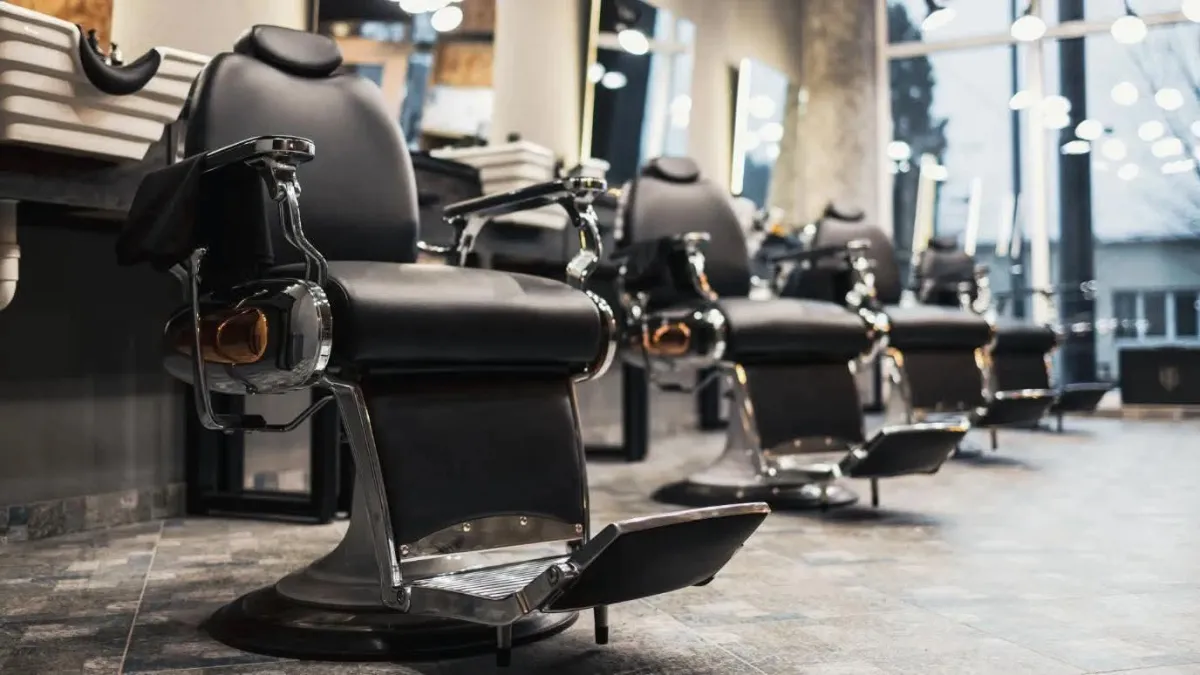 a barber shop with a brick wall and lots of chairs