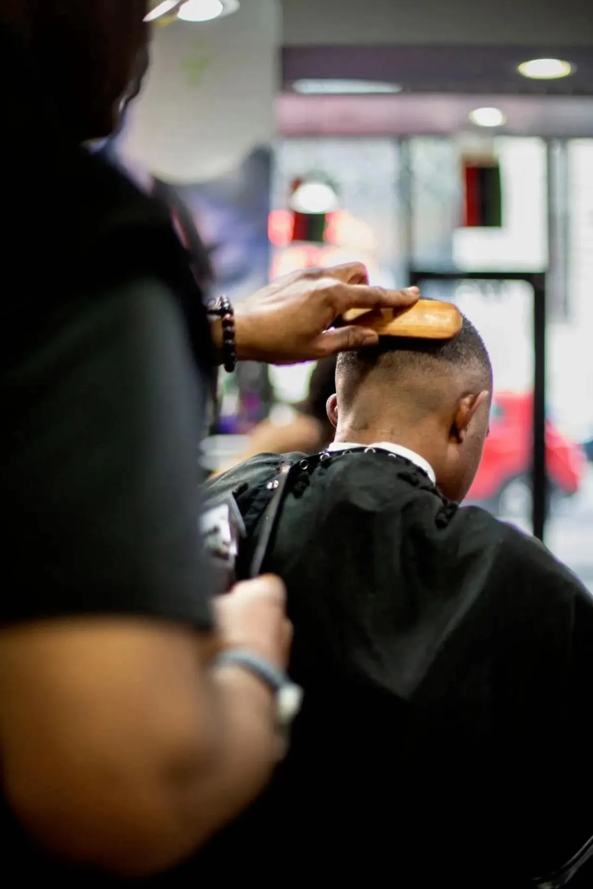 man cutting hair of man