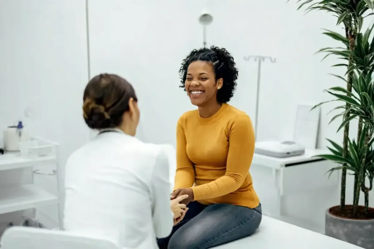 Patient speaking with a medical provider during a gynecology consultation