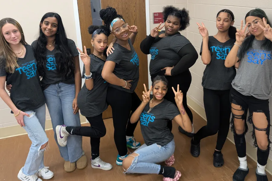 Teens posing for photo in TWTS shirts