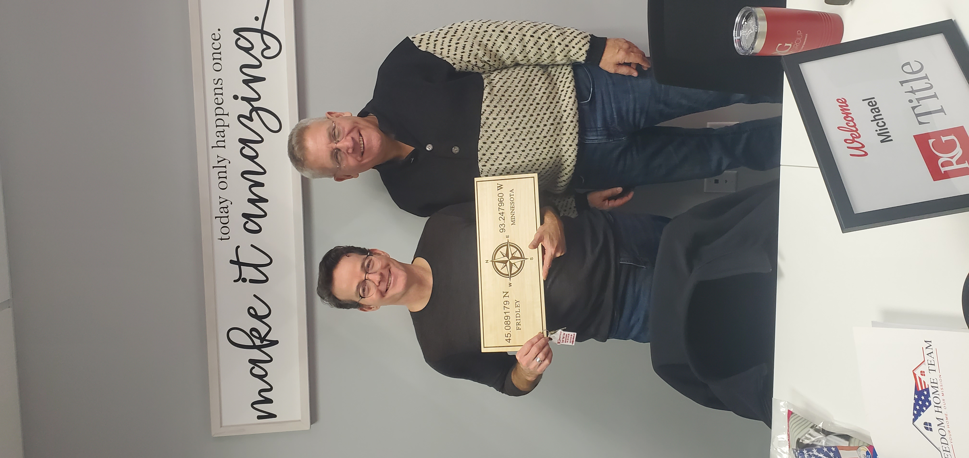 Veteran shaking hands with real estate agent in front of a home