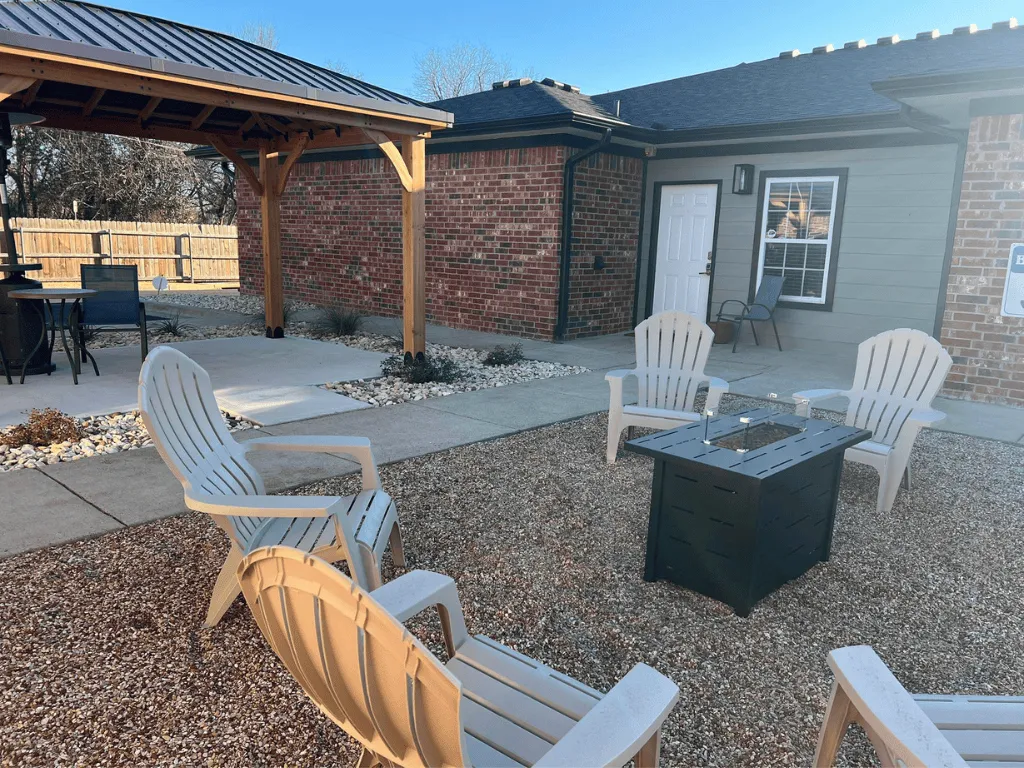 Photo of the shared communal space with chairs, tables, veranda, etc. at Bear Creek At Baylor's student housing apartments.
