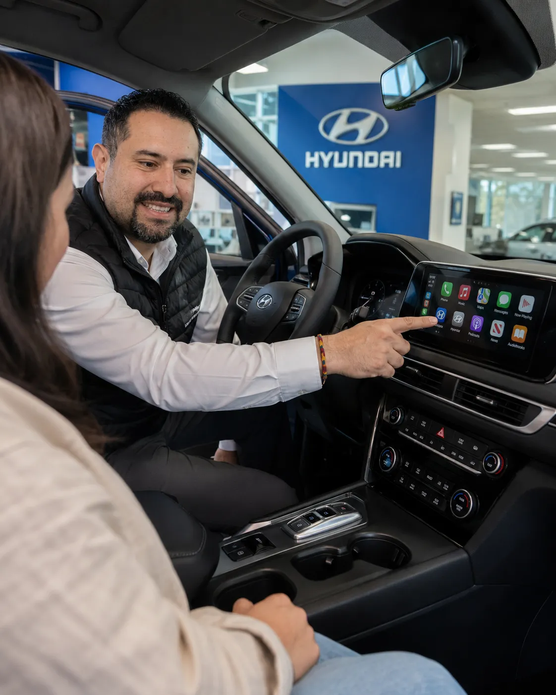 Person browsing luxury vehicles on a tablet
