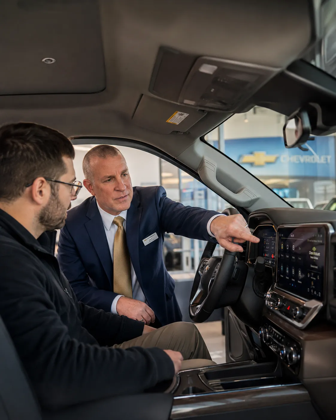 Person browsing luxury vehicles on a tablet