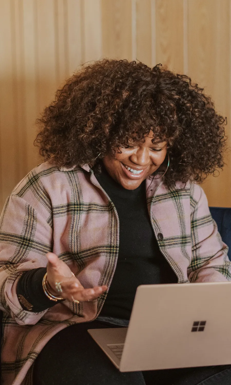 Woman smiling at her laptop