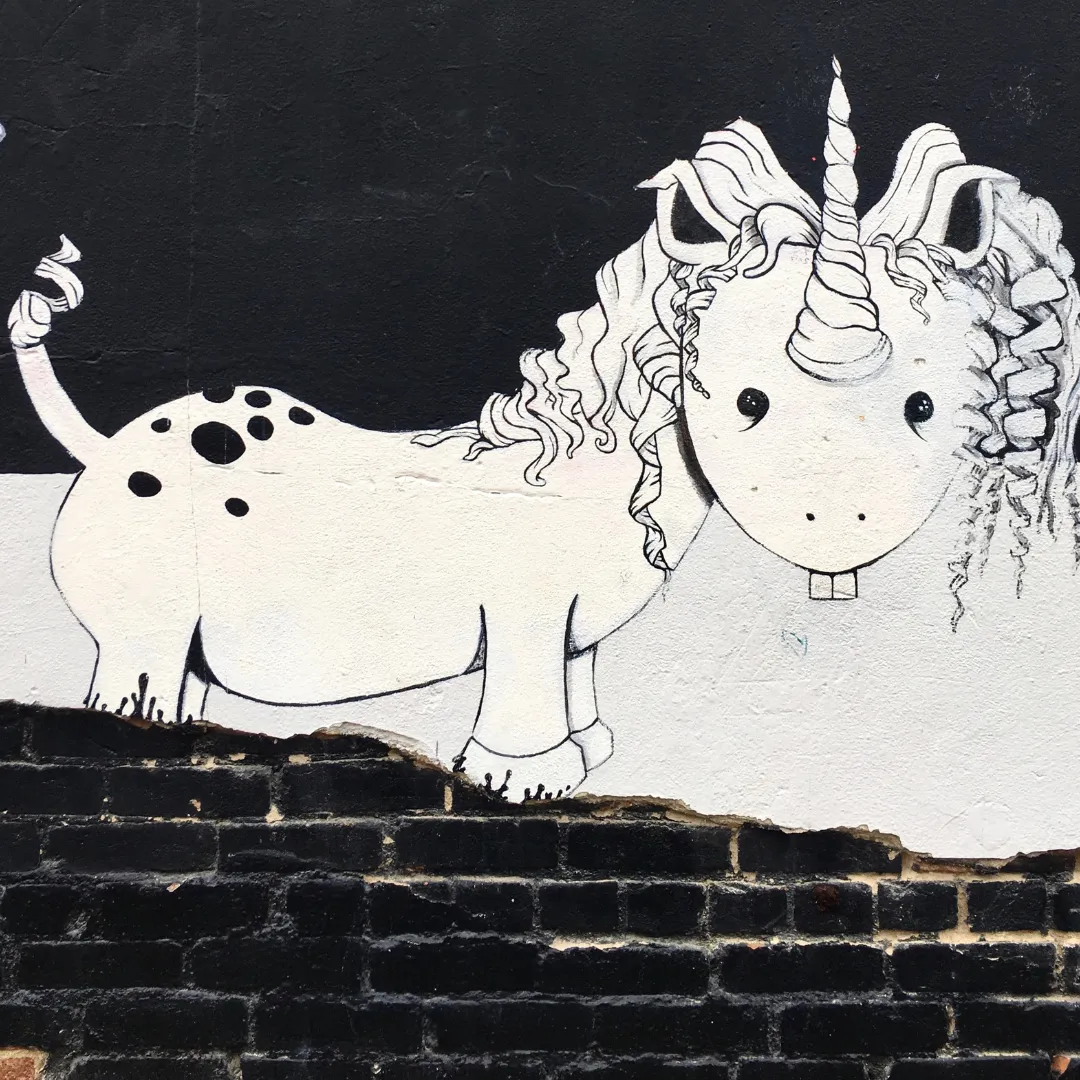 Black and white graffiti drawing of a unicorn with buckteeth