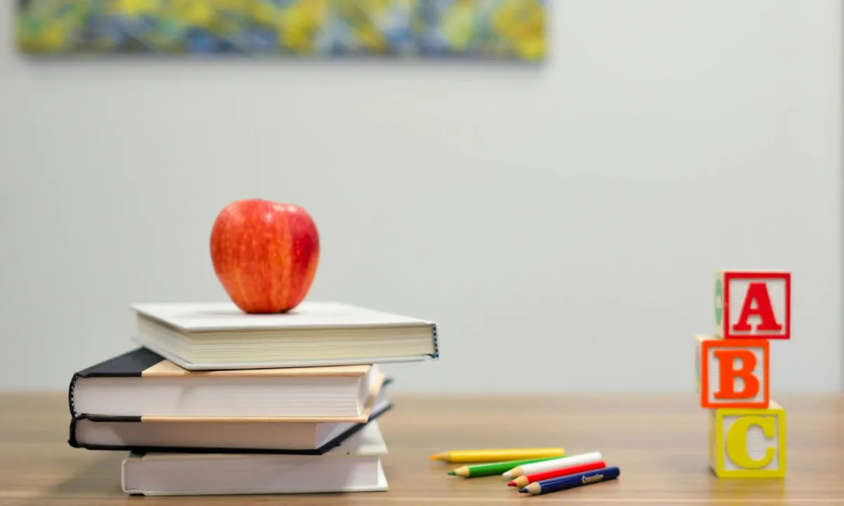 Books, an apple, some coloured pencils and ABC blocks