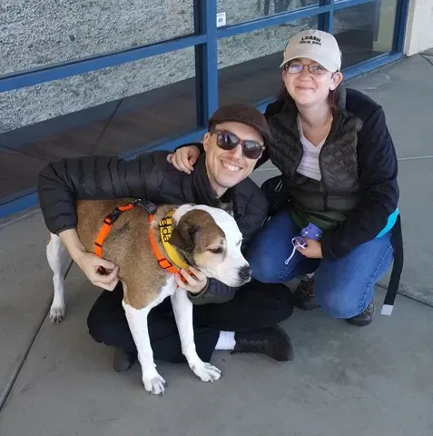 two people with a dog