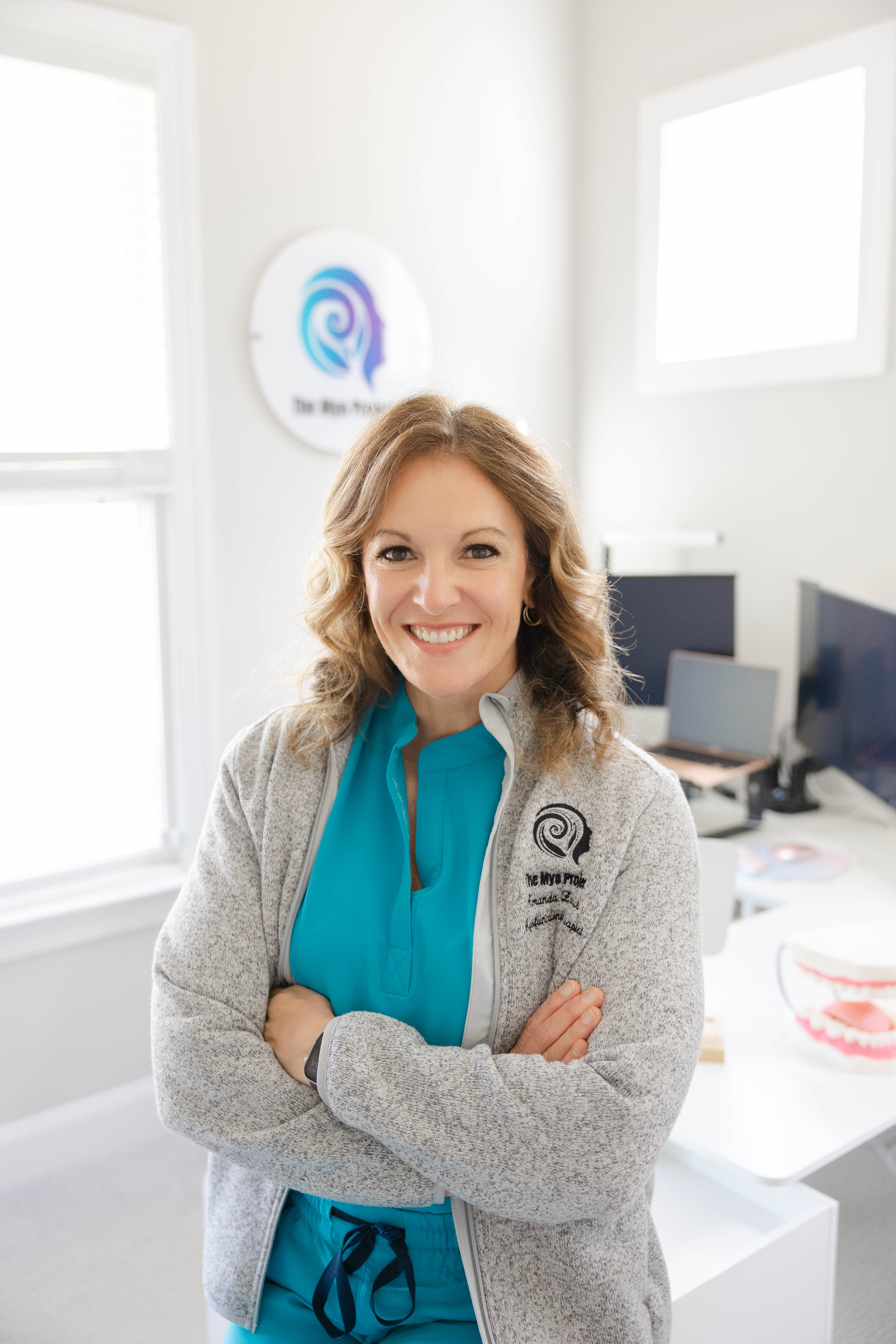Adult patient performing guided myofunctional exercise in clinic, smiling in soft natural light.