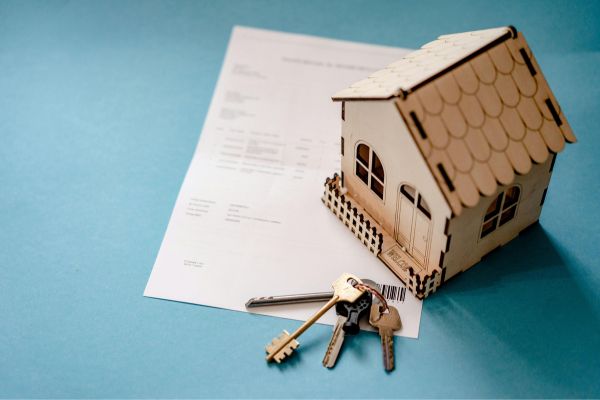 Property Deed with House Keys on Table